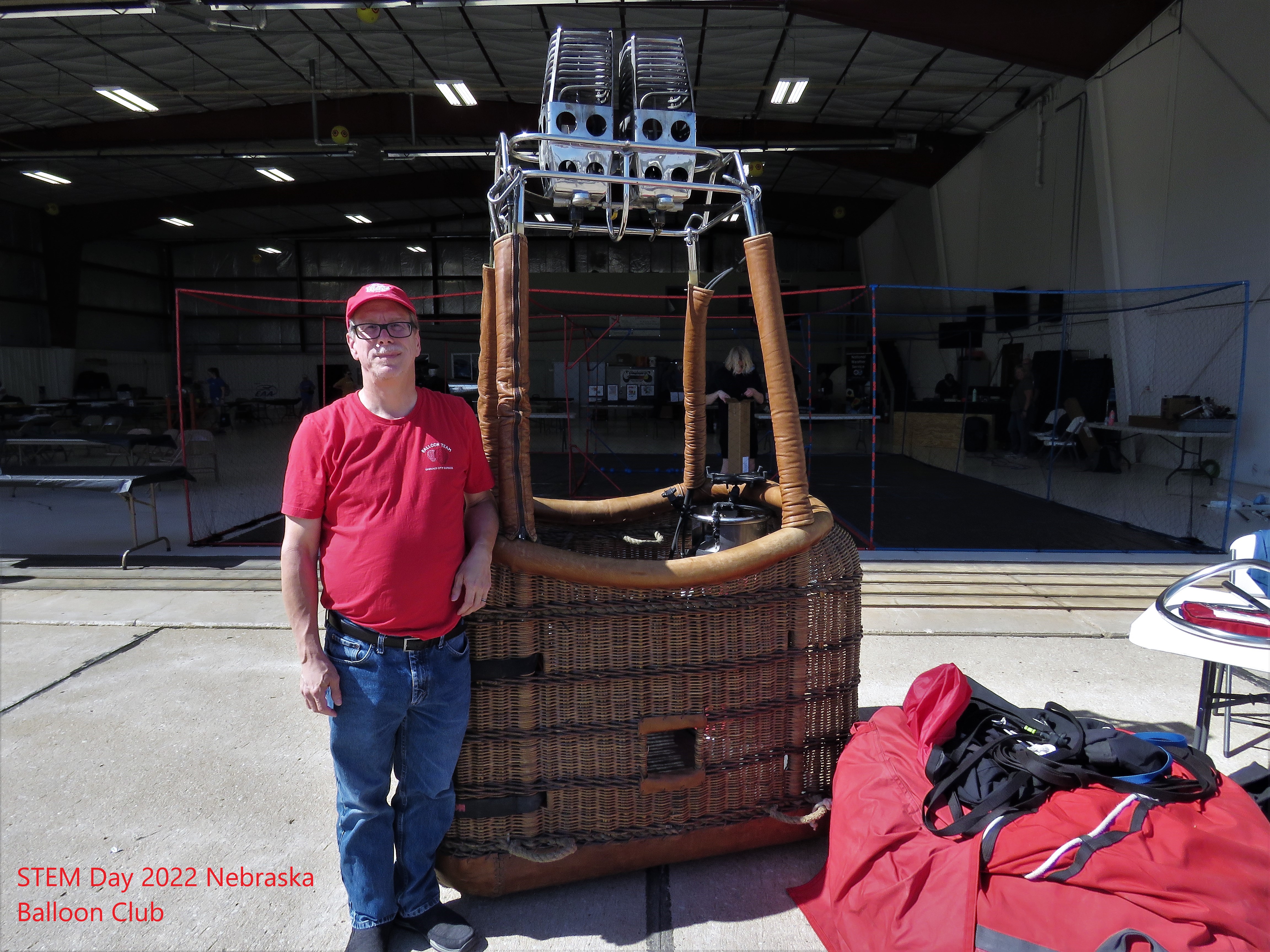 man standing in front of hot air baloon basket